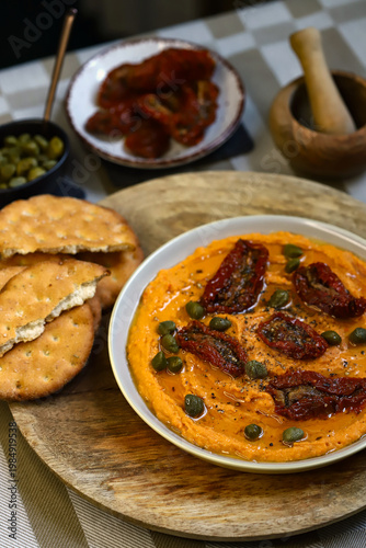 Hummus with sun-dried tomatoes and capers