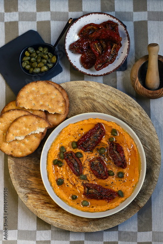 Hummus with sun-dried tomatoes and capers
