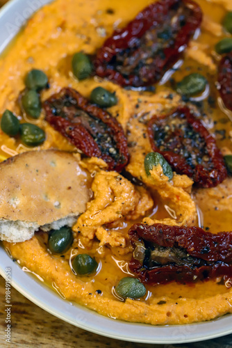 Hummus with sun-dried tomatoes and capers