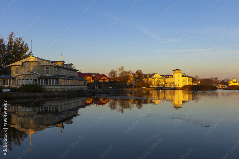 Fototapeta premium Historic town reflected in calm water at sunrise, Haapsalu Estonia