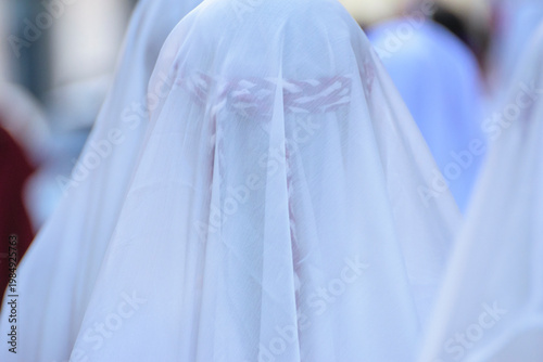Penitent with a white veil in a procession The Concept of Faith