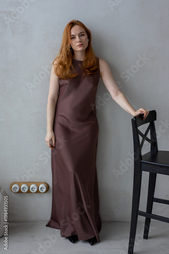 Portrait of young redhead woman with freckles in studio. Sensual expressive happy woman
