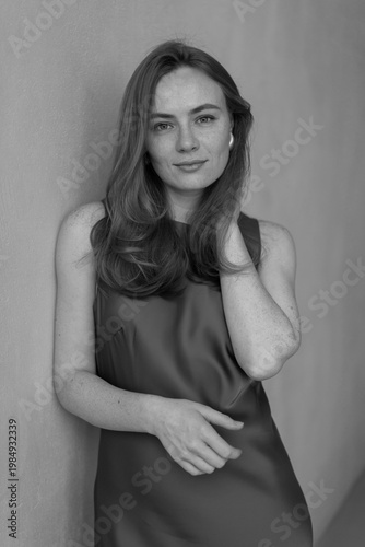 Portrait of young redhead woman with freckles in studio. Sensual expressive happy woman