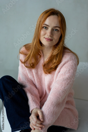 Portrait of young redhead woman with freckles in studio. Sensual expressive happy woman