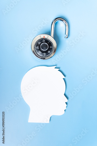 Concept of intelligence and good mental health, open padlock simulating openness and knowledge, silhouette of a person on a blue background