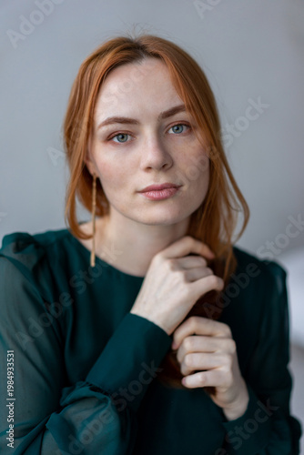 Portrait of young redhead woman with freckles in studio. Sensual expressive happy woman