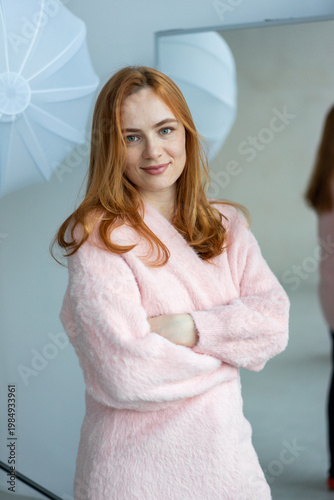 Portrait of young redhead woman with freckles in studio. Sensual expressive happy woman