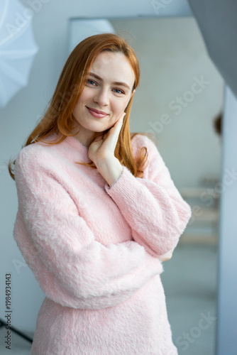 Portrait of young redhead woman with freckles in studio. Sensual expressive happy woman