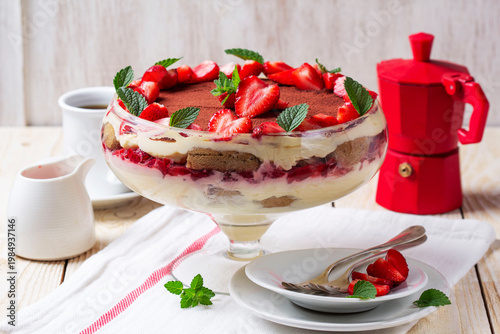 Strawberry Tiramisu Trifle Dessert with Cream Layers and Mint in Glass Bowl