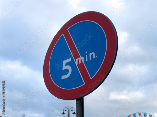 Parking Sign Showing No Parking Allowed With a Time Limit of 5 Minutes, Likely Seen in a Busy Urban Area During the Day