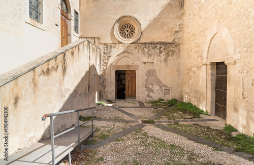 Wallpaper Mural The external entrance to the Catacombs of San Giovanni in Syracuse, Sicily, Italy. Historic archaeological site and early Christian burial complex featuring ancient stone architecture. Torontodigital.ca