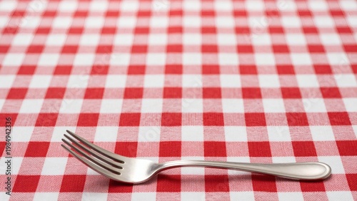 Single Silver Fork on Red and White Checkered Gingham Tablecloth with Ample Copy Space