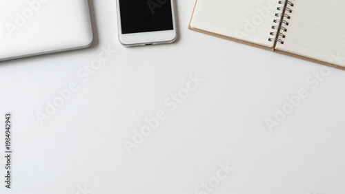 Minimalist White Desk Workspace with Smartphone Notebook and Laptop Edge with Large Copy Space Banner