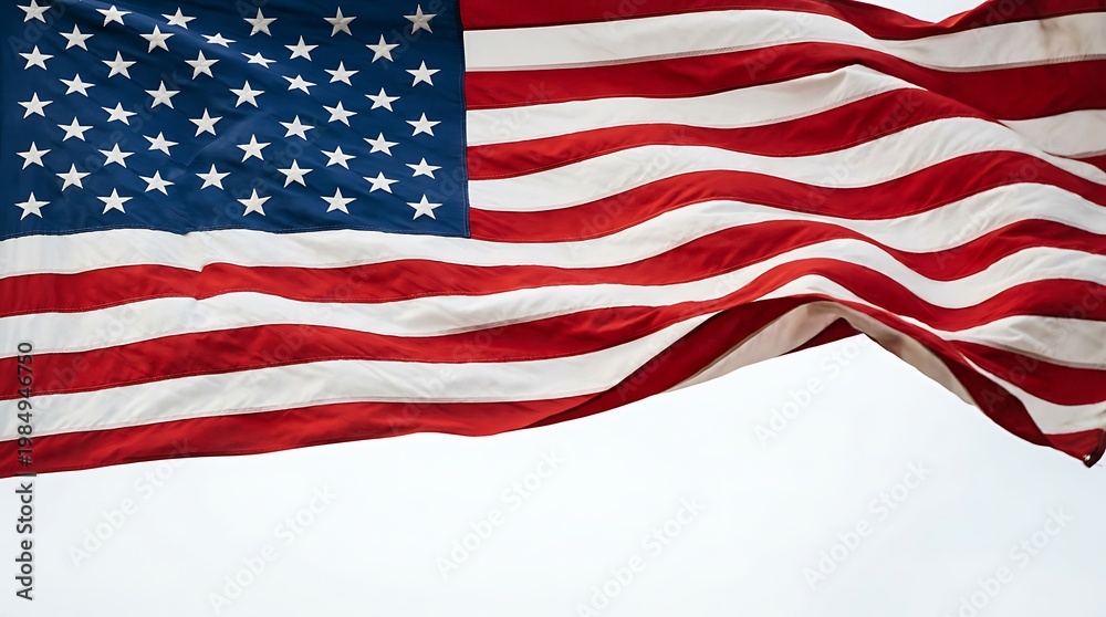 Obraz premium American flag waving in the wind with red white and blue colors and fifty white stars on a clear sky