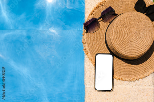 Poolside phone. Hotel's summer pool. Phone with a white display.