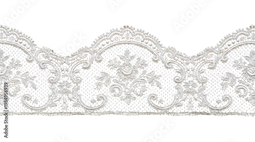 Fotografie Delicate white scalloped lace border ribbon with intricate floral embroidery on