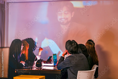 Fotografija Professional IT squad analyzing machine learning data with a remote expert via projector