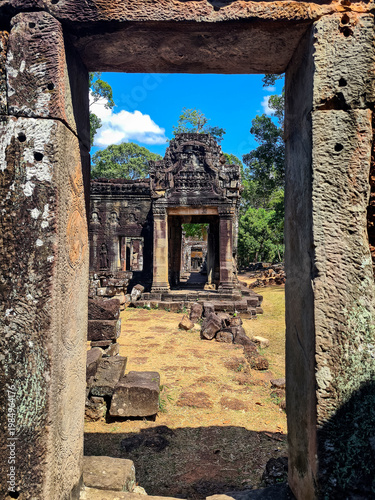View through a stone doorway at Banteay Kdei Temple in Angkor, Cambodia, showcasing ancient Khmer architecture and depth perspective.