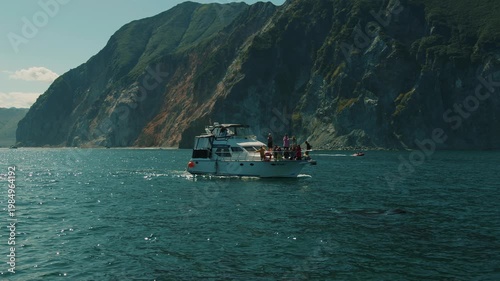 Kamchatka, Russia - August 26, 2025: Killer whales swam close to yacht carrying tourists and released plumes of steam as they surfaced. Slow motion.