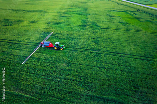 Aerial view of a tractor with a sprayer in a field