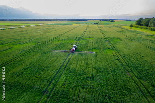 Aerial view of a tractor with a sprayer in a field