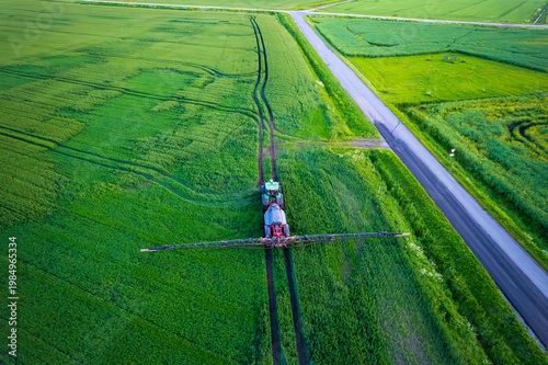 Aerial view of a tractor with a sprayer in a field