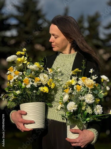 Woman Holding Spring Floral Arrangement in White Pot