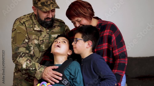 Happy latin american mother kissing her diverse children at home - Family love and disability care concept