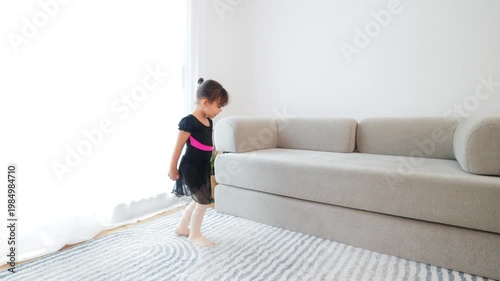 Happy latin little girl dancing ballet at home in ballerina dress - Childhood activity concept - ugc content
