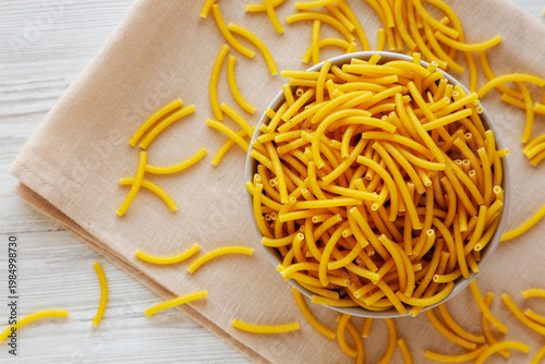 Organic Dry Raw Macaroni Pasta in a Bowl, top view.