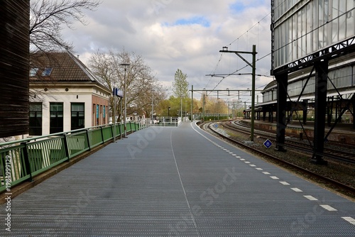 Quiet street near Haarlem station with tram lines and buildings. The scene captures calm urban atmosphere in the city.
