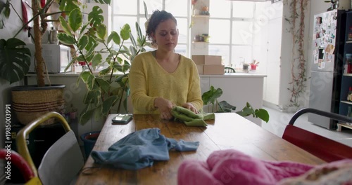 Young woman taking a photo to sell clothes online