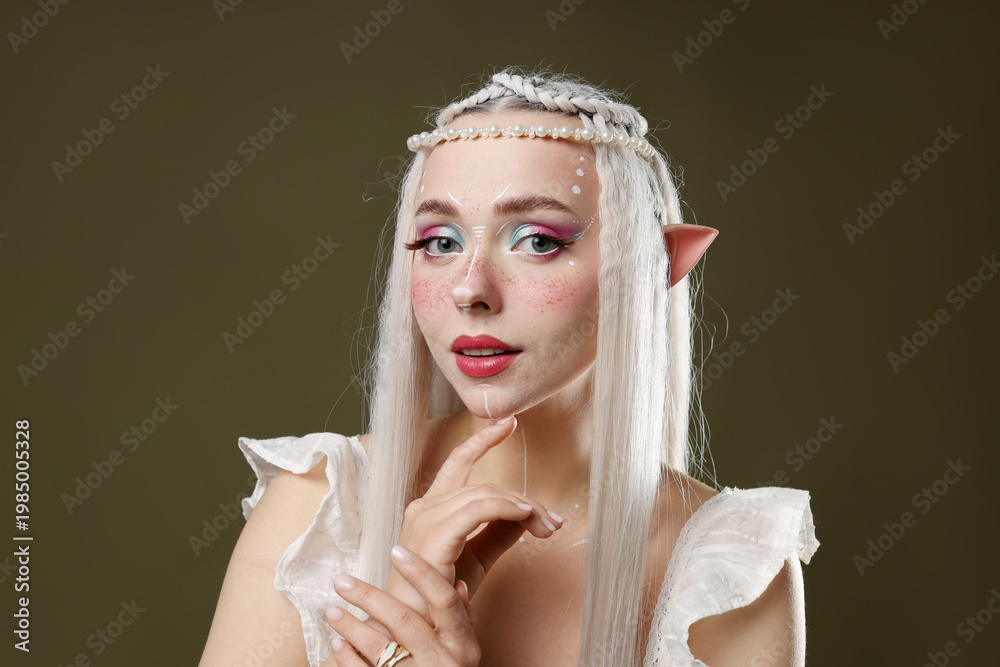 Fototapeta premium Beautiful elf girl on dark olive background