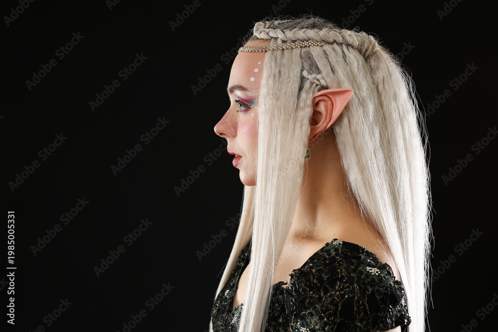 Fototapeta premium Beautiful girl dressed as elf on black background, space for text