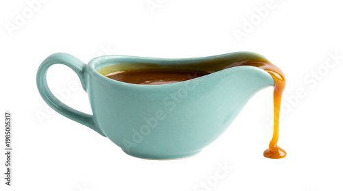 Canvastavla Light blue ceramic gravy boat with thick caramel sauce pouring out, isolated on