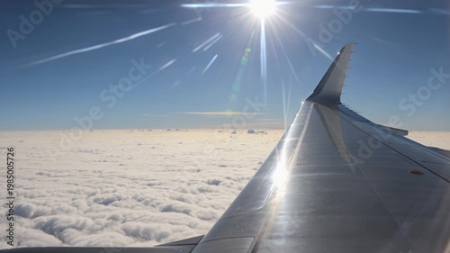 Jet Perspective Above a Cloud Ocean Under Brilliant Blue Sky With Metallic Wings Visible