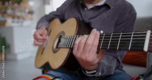Young Adult Male Playing Guitar, Learning Music at Home
