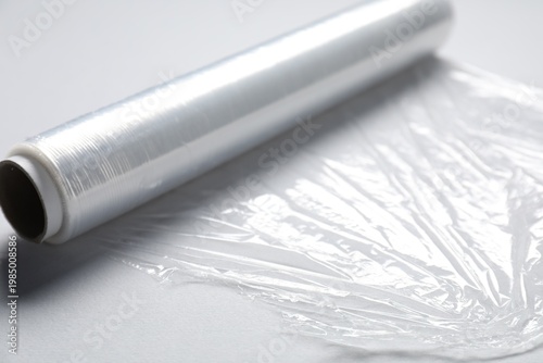 Fotografija Roll of cling film on light background, closeup