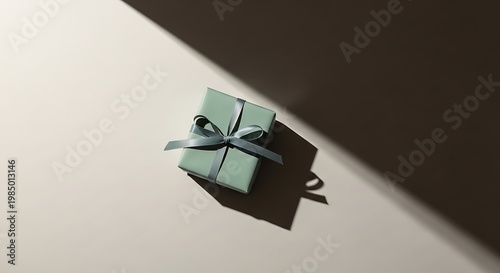 A beautifully wrapped gift box with a ribbon on a plain surface