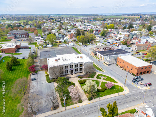 Aerial view of a modern suburban neighborhood with residential housing, green spaces, and local landmarks in Pennsylvania.