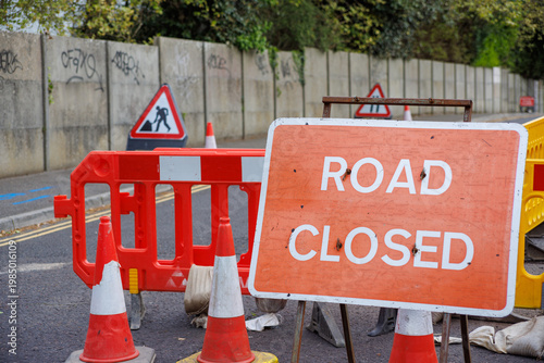 Road Closed Sign with Traffic Cones and Barriers on Urban Street