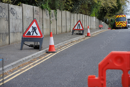 Road Closed Sign with Traffic Cones and Barriers on Urban Street