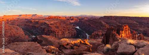 This scenic panorama was captured at sunset deep within Canyonlands National Park and features a bend in the Colorado River surrounded by rugged canyon country. 