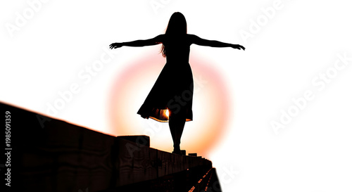 A woman stands on a wall with her arms outstretched in a serene and peaceful pose during sunset