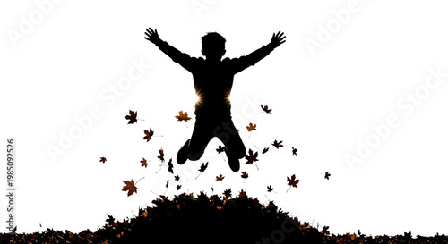 A silhouette of a joyful person jumping in the air surrounded by falling autumn leaves