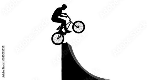 A black silhouette of a man riding a bicycle on a ramp