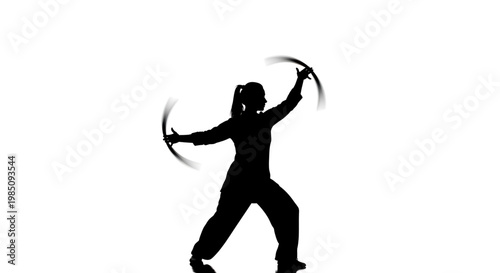 A black silhouette of a person performing a martial arts move with two curved blades on a white background
