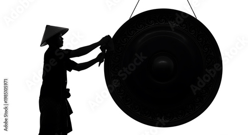 A silhouette of a person playing a large gong with a traditional hat on a white background