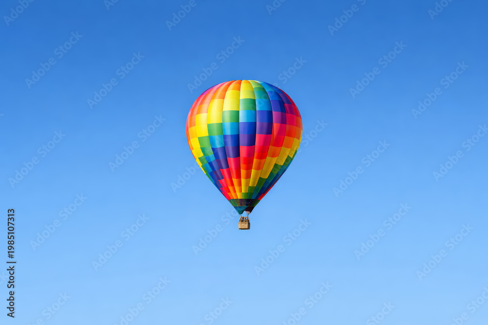 Obraz premium Colorful hot air balloon soaring against a clear blue sky