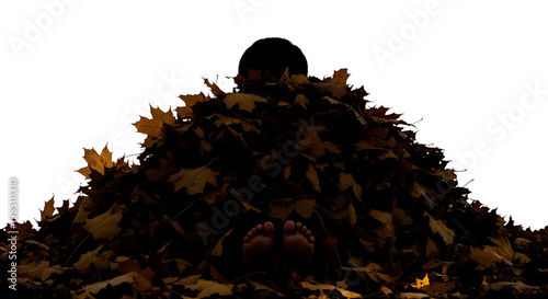 A silhouette of a person buried under a large pile of autumn leaves